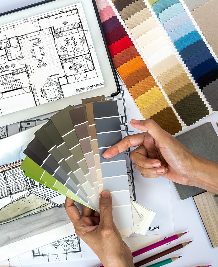 Black interior designer making color selections and planning furniture placement.