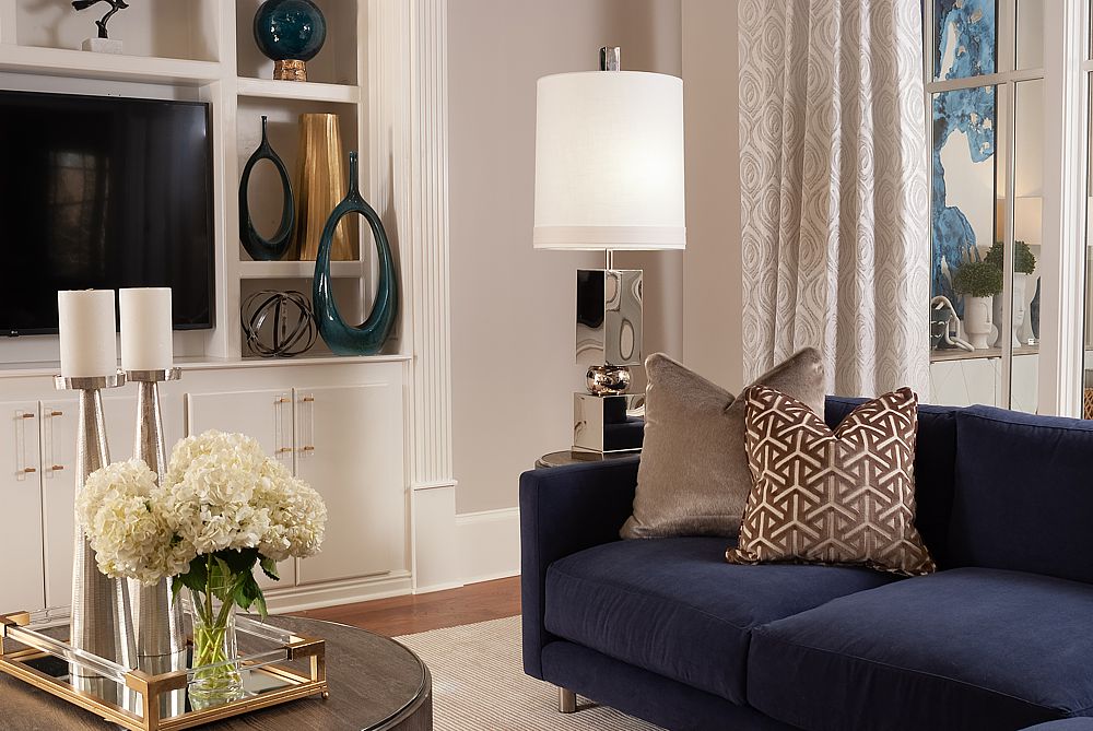 A neutral space that is never dull due to the layered textiles such as the patterned rug, custom draperies, pillows and the insertion of reflective surfaces and lighting.