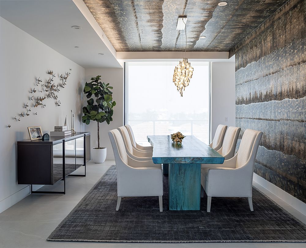 Custom wallpaper hugs the wall and ceiling in this modern dining room.